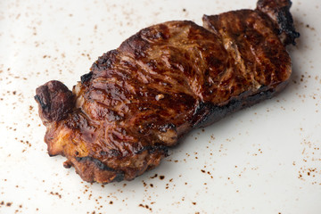 Steak. Grade A, grass fed angus beef. Traditional classic New York steakhouse menu favorite. T-bone steak, bone in, cooked to medium to rare and sliced. 