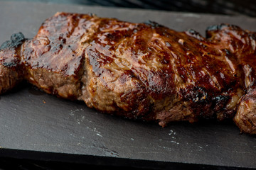 Steak. Grade A, grass fed angus beef. Traditional classic New York steakhouse menu favorite. T-bone steak, bone in, cooked to medium to rare and sliced. 