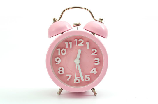 Sleep hygiene, wake up ring and old fashioned clocks concept with pink retro style alarm clock isolated on white background and clipping path cutout