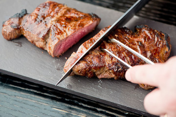 Steak. Grade A, grass fed angus beef. Traditional classic New York steakhouse menu favorite. T-bone steak, bone in, cooked to medium to rare and sliced. 