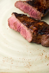Steak. Grade A, grass fed angus beef. Traditional classic New York steakhouse menu favorite. T-bone steak, bone in, cooked to medium to rare and sliced. 