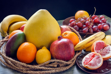 Fruit still life on an old countertop and a dark background.