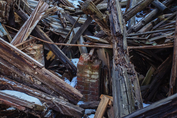 Collapsed ruined old wooden abandoned house in poor district