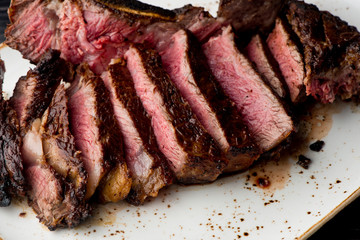 Steak. Grade A, grass fed angus beef. Traditional classic New York steakhouse menu favorite. T-bone steak, bone in, cooked to medium to rare and sliced. 