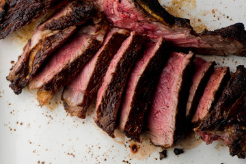 Steak. Grade A, grass fed angus beef. Traditional classic New York steakhouse menu favorite. T-bone steak, bone in, cooked to medium to rare and sliced. 