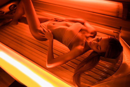 Beautiful Young Woman Tanning Skin Treatment In Modern Solarium