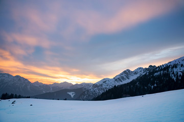 Sunset in the mountains with snow during winter in Italy