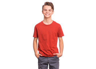 T-shirt design concept. Teen boy in blank red t-shirt, isolated on white background. Mock up template for print. Happy child with hands in pockets, looking at camera, front view. - 327819914