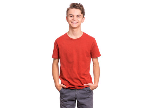 T-shirt design concept. Teen boy in blank red t-shirt, isolated on white background. Mock up template for print. Happy child with hands in pockets, looking at camera, front view.