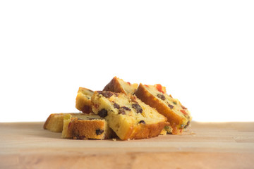 Fruit cakes on the wooden chopping board isolated over white background.