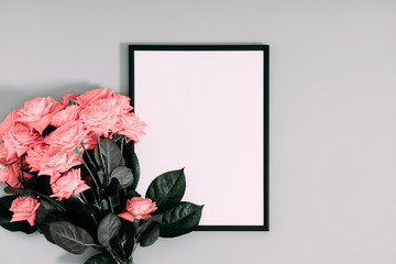 Beautiful flowers composition. Blank frame for text, pink rose flowers on gray background. Valentines Day, Birthday, Happy Women's Day, Mother's day. Flat lay, top view, copy space
