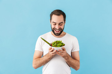 Handsome young bearded man wearing t-shirt standing