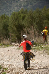 Obraz premium two mountaineer runs through the field with climbing equipment between mountains