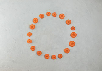 Flat lay, circle of orange carrots, blank for greeting card