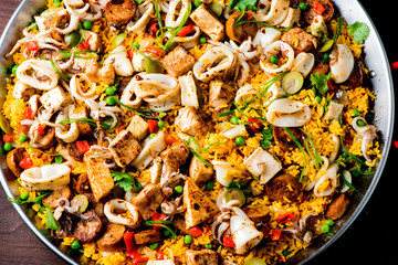 Paella. Traditional classic Spanish seafood dish with fresh seafood, shrimp, mussels, clams, squid cooked in fish broth with saffron and rice garnished with cilantro. 