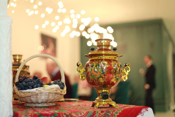 Russian traditional tea in samovar with sushki. Russian ornament.