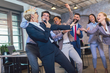 Funny teambuilding indoors activity. Business people making team training exercise during team...