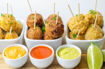 Various mini chicken kievs and sweet potato falafels served with sauces