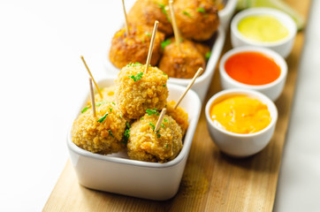 Various mini chicken kievs and sweet potato falafels served with sauces