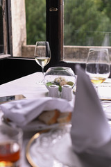 Glass of wine on the table by the window. Interior of a classic restaurant in an old castle. Traveling in Europe. Served tables and antiquity.