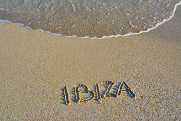 Sandy beach and wave on Ibiza island.