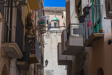Balconies of town houses seen from narrow street in historic part of Trapani city, Sicily Island in Italy