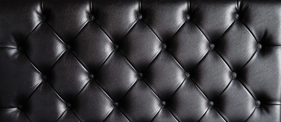 Black leather sofa texture background.