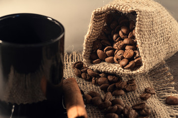 Seeds of aromatic, roasted coffee in a cup, background, texture