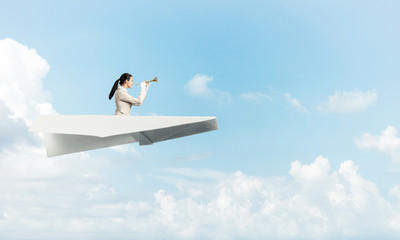 Attractive woman playing trumpet brass