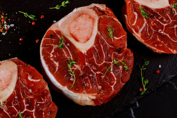 Three pieces of raw fresh beef shank bone in with spices Close up.