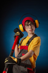 the child the Builder costume posing with a work tool