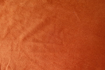 Orange artificial suede fabric directly from above