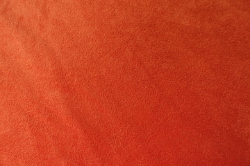 View of reddish orange artificial suede fabric from above