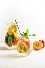 Detox peach beverage in glass garnish mint. Close up.
