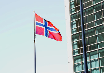 Norway flag waving on the wind with blue sky in the background