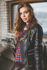 Naklejka na ściany i meble Cool sensual biker girl in black leather jacket