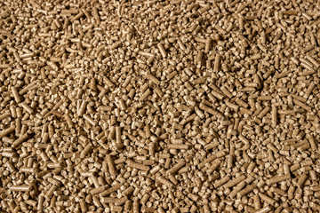 Wood pellets in the background. Biofuels. Cat litter.