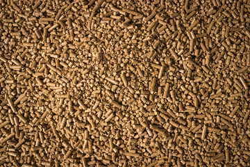 Wood pellets in the background. Biofuels. Cat litter.