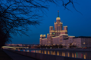 Obraz premium View of illuminated Stalin skyscraper on the Kotelnicheskaya embankment and Moscow River at night