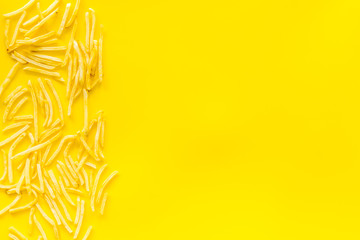 French fries frame on yellow table top-down copy space