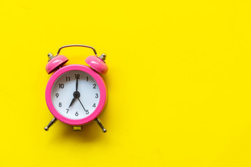 Alarm green vintage alarm clock falling on the floor with color background. Morning and Start up...