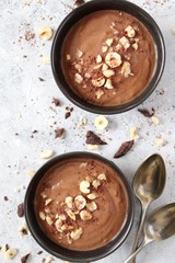 Protein chocolate smoothie with banana and nuts. Top view with copy space. Healthy food.
