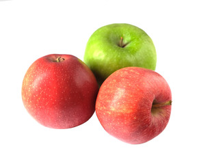 green and two red apples on a white background
