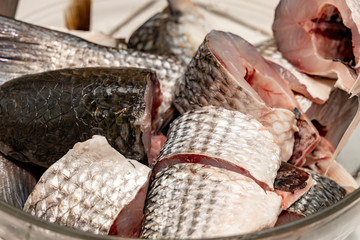 Raw mullet fish cut on a plate.