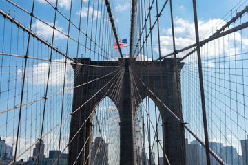 Arches on the Brooklyn Bridge with an American Flag in New York City