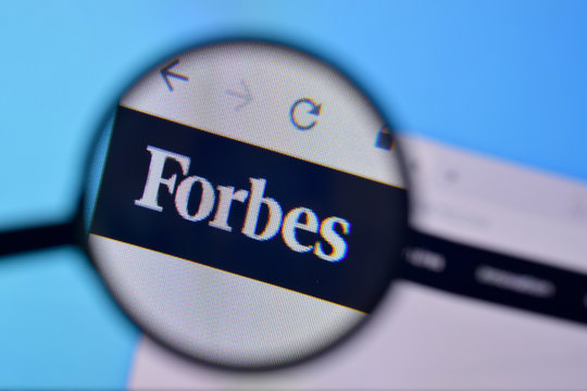 Homepage of forbes website on the display of PC, url - forbes.com.