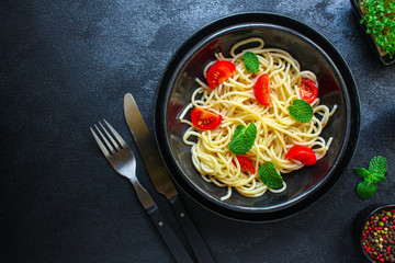 spaghetti pasta with tomatoes, Italian cuisine main dish, vegetarian menu concept background. top view. copy spaces