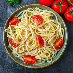 spaghetti pasta with tomatoes, Italian cuisine main dish, vegetarian menu concept background. top view. copy spaces