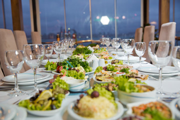 Salads and gums . Set of a dish with spoon, fork and knife on white table.Table setting on white table .