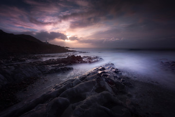 Morning at Bracelet Bay with a long exposure over the rock pools on the Gower peninsula in Swansea, South Wales, UK